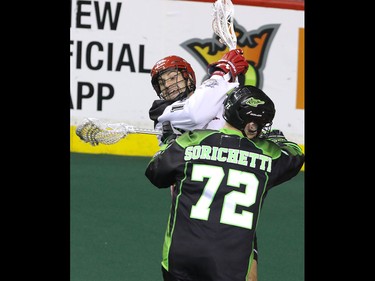 Calgary Roughnecks Wesley Berg collides with Saskatchewan Rush Adrian Sorichetti in NLL action at the Scotiabank Saddledome in Calgary, Alta. on Sunday February 28, 2016. Mike Drew/Postmedia