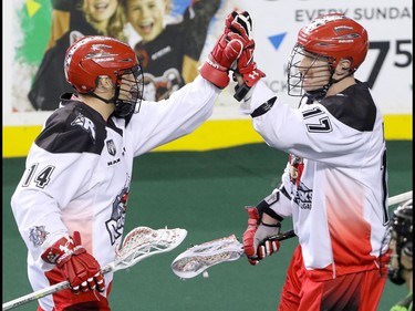 Calgary Roughnecks Wesley Berg and Curtis Dickson celebrate a goal against the Saskatchewan Rush in NLL action at the Scotiabank Saddledome in Calgary, Alta. on Sunday February 28, 2016. Mike Drew/Postmedia