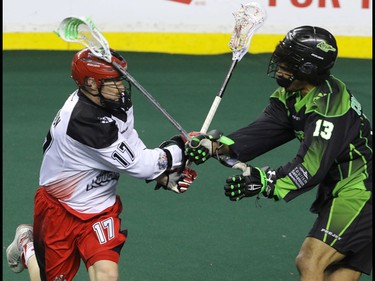 Calgary Roughnecks Curtis Dickson and Saskatchewan Rush Jeff Cornwall trade blows in NLL action at the Scotiabank Saddledome in Calgary, Alta. on Sunday February 28, 2016. Mike Drew/Postmedia