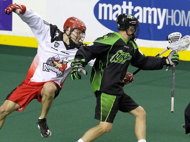 Calgary Roughnecks Curtis Manning tries to slow down Saskatchewan Rush Zak Greer in NLL action at the Scotiabank Saddledome in Calgary, Alta. on Sunday February 28, 2016. Mike Drew/Postmedia