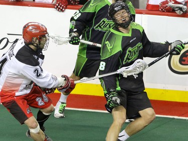 Calgary Roughnecks Scott Carnegie Saskatchewan Rush Zak Greer in NLL action at the Scotiabank Saddledome in Calgary, Alta. on Sunday February 28, 2016. Mike Drew/Postmedia