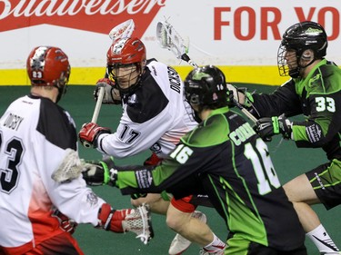 Calgary Roughnecks Curtis Dickson makes a rush past teammate Tyler Digby and Saskatchewan Rush gChris Corbiel and John Lafontaine in NLL action at the Scotiabank Saddledome in Calgary, Alta. on Sunday February 28, 2016. Mike Drew/Postmedia