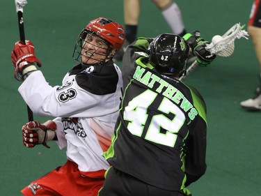 Calgary Roughnecks Jon Harnett battles for the ball with Saskatchewan Rush Mark Mathews in NLL action at the Scotiabank Saddledome in Calgary, Alta. on Sunday February 28, 2016. The Roughnecks lost in overtime 12-11. Mike Drew/Postmedia