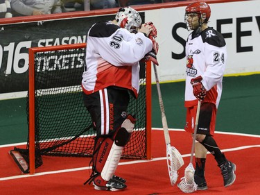 Calgary Roughnecks goalie Mike Poulin and Scott Carnegie disappointed by their loss to the Saskatchewan Rush in overtime in NLL action at the Scotiabank Saddledome in Calgary, Alta. on Sunday February 28, 2016. The Roughnecks lost in overtime 12-11. Mike Drew/Postmedia