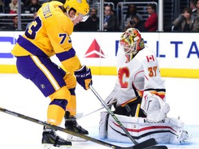 Flames goalie Joni Ortio  makes a save on Tyler Toffoli of the Kings during the second period at Staples Center on Tuesday in Los Angeles.