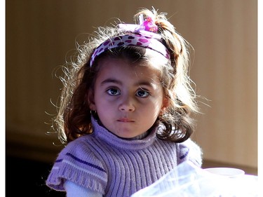 A young Syrian refugee girl settles into life with her family at a hotel.