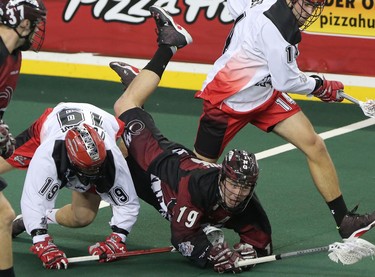 Colorado Mammoth Cameron Holding, right, collides with Calgary Roughnecks Reilly O'Connor during game action at the Scotiabank Saddledome in Calgary, Alta. on Saturday February 13, 2016. Leah Hennel/Postmedia