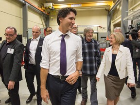 Prime Minister Justin Trudeau, centre, and Alberta Premier Rachel Notley, right, tour the International Brotherhood of Electrical Workers training facility in Edmonton, Alberta, on Wednesday, February 3, 2016. THE CANADIAN PRESS/Amber Bracken