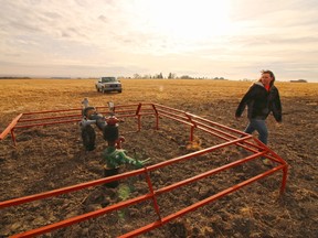 Kelly Nelson walks past an abandoned gas well on the farm she owns with her husband Gord.