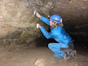 Parks Canada's Anne Forshner works in a cave in Banff National Park in September 2015.
