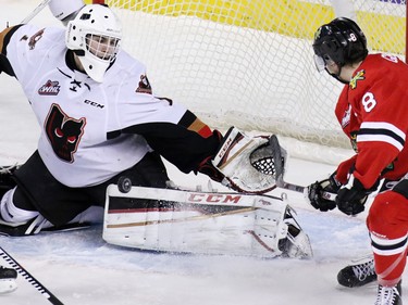 Calgary Hitmen goalie Nik Amundrud stops this Portland Winterhawks' scoring chance from Cody Glass during WHL action at the Scotiabank Saddledome on Tuesday February 23, 2016.