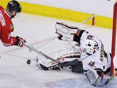 Calgary Hitmen goalie Nik Amundrud stops this shot from the Portland Winterhawks Alex Schoenborn during first period WHL action at the Scotiabank Saddledome on Tuesday February 23, 2016.