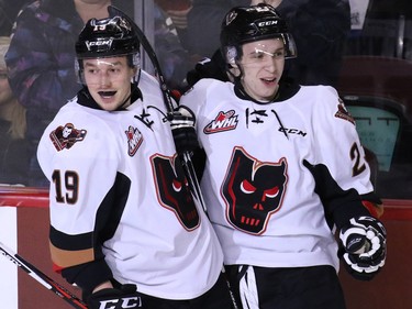 Calgary Hitmen Radel Fazleev congratulates Travis Sanheim after he scored the team's first goal on the Portland Winterhawks' during first period WHL action at the Scotiabank Saddledome on Tuesday February 23, 2016.