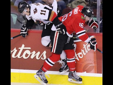 Calgary Hitmen Beck Malenstyn and the Portland Winterhawks' Blake Heinrich collide during first period WHL action at the Scotiabank Saddledome on Tuesday February 23, 2016.