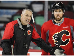 Calgary Flames coach Bob Hartley talks with winger David Jones during practice at the Saddledome Thursday, Nov. 19, 2015.