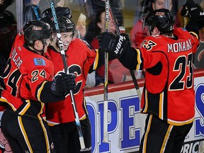 Calgary Flames Johnny Gaudreau celebrates with teammates Jiri Hudler and Sean Monahan after scoring against the Carolina Hurricanes in Wednesday's win at the Saddledome.