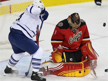 Calgary Flames Jonas Hiller with a save against Toronto Maple Leafs during NHL hockey in Calgary, Alta., on Tuesday, February 9, 2016. Al Charest/Postmedia
