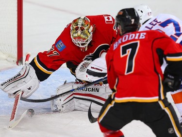 Calgary Flames Joni Ortio makes a save on a shot by Anders Lee of the New york islanders during NHL hockey in Calgary, Alta., on Thursday, February 25, 2016.