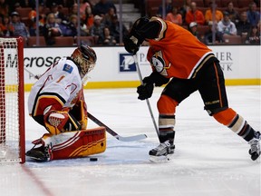 Flames goalie Jonas Hiller stops a shot from Ducks forward Corey Perry in Calgary's 5-2 loss to Anaheim at the Honda Center on Sunday.
