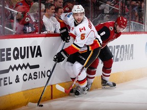 GLENDALE, AZ - FEBRUARY 12:  Mark Giordano #5 of the Calgary Flames skates with the puck ahead of Tobias Rieder #8 of the Arizona Coyotes during the first period of the NHL game at Gila River Arena on February 12, 2016 in Glendale, Arizona.