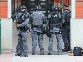 Calgary Police surround Heritage Hall at SAIT Polytechnic in northwest Calgary, Alta on Wednesday February 10, 2016. Police responded to reports of a man making threats. The suspect was later arrested at a home.