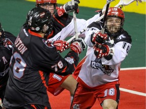 Calgary Roughnecks Mike Carnegie tries to stop a shot by Vancouver Stealth Jordan Durston in NLL action at the Scotiabank Saddledome in Calgary, Alta. on Saturday January 30, 2016.