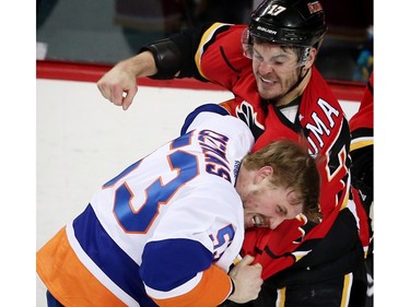 Calgary Flames Lance Bouma fights Casey Cizikas of the New york islanders during NHL hockey in Calgary, Alta., on Thursday, February 25, 2016.