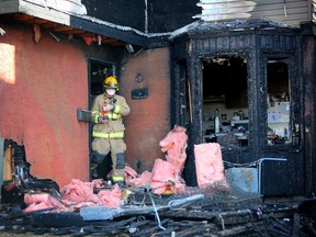 Firefighters investigate the scene of an early morning fire at a Huntington Hills condo complex in Calgary, Ab., on Saturday February 27, 2016.