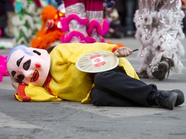 The Happy Buddhua pretends to nap before the Dragon Dance during a Chinese New Year celebration outside of the Chinese Cultural Centre in downtown Calgary, Alta., on Sunday, Feb. 7, 2016. The Chinese community is celebrating the Year of the Monkey. Lyle Aspinall/Postmedia Network