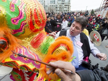 Liberal MP Kent Hehr helps put the finishing paint touches on the star of the show before the Dragon Dance during a Chinese New Year celebration outside of the Chinese Cultural Centre in downtown Calgary, Alta., on Sunday, Feb. 7, 2016. The Chinese community is celebrating the Year of the Monkey. Lyle Aspinall/Postmedia Network