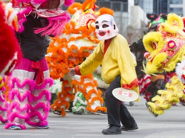 The Happy Buddha watches the Lion Dance during a Chinese New Year celebration outside of the Chinese Cultural Centre in downtown Calgary, Alta., on Sunday, Feb. 7, 2016. The Chinese community is celebrating the Year of the Monkey. Lyle Aspinall/Postmedia Network