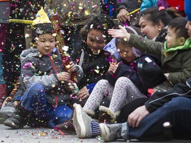 A confetti blaster is popped during a Chinese New Year celebration outside of the Chinese Cultural Centre in downtown Calgary, Alta., on Sunday, Feb. 7, 2016. The Chinese community is celebrating the Year of the Monkey. Lyle Aspinall/Postmedia Network