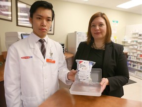 CO-OP Pharmacy Manager Gabriel Chang (L) and Brandy Payne, Associate Minister of Health display a take-home naloxone kit.