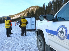 Cochrane Search and Rescue members talk near Elbow Falls after four missing hikers were reported safe.