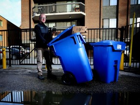 Randy Bobyk with Condo Recycling Solutions drops off recycle bins at a Calgary condo building.