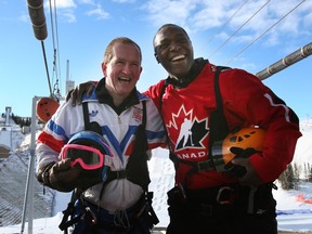 Former ski jumper Eddie "The Eagle" Edwards and Devon Harris, a member of the original four-man Jamaican bobsled team, at the base of the 90 metre ski jump  at Canada Olympic Park twenty years after they were both in Calgary for the '88 Olympics.