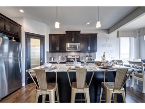 The kitchen in the Varscona by Genesis Builder Group in EvansRidge.