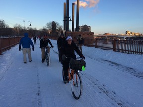 Cyclists pedalling through the Minneapolis snow.