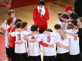 University of Calgary men's  volleyball players console each other after  they were defeated by visiting Trinity Western Spartans three games to one during CIS Canada West quarter-finals Sunday afternoon at the Jack Simpson Gym in Calgary.