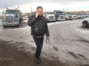 Larry Graham walks the yard past vehicles and equipment to be sold at auction soon at his business Graham Auctions.