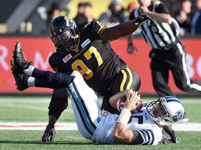 Toronto Argonauts' Ricky Ray (15) is sacked by Hamilton Tiger-Cats' Ted Laurent during second half CFL Eastern Division Semifinal football action, in Hamilton, Ont., on Sunday, Nov. 15, 2015. THE CANADIAN PRESS/Frank Gunn