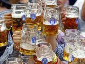 FILE - In this Sept. 19, 2015 file photo, people celebrate the opening of the 182nd Oktoberfest beer festival in Munich, southern Germany. Traces of pesticides have been found in German beer.