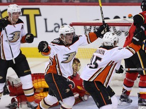 Anaheim Ducks players celebrate their fifth goal against the Calgary Flames during NHL action in Calgary on Feb. 15, 2016.