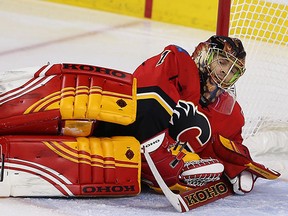 Calgary Flames goalie Jonas Hiller reacts after giving up a goal to the Anaheim Ducks during NHL hockey in Calgary on Feb. 15, 2016.