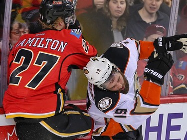 Calgary Flames Dougie Hamilton collides with Patrick Maroon of the Anaheim Ducks during NHL hockey in Calgary, Alta., on Monday, February 15, 2016. Al Charest/Postmedia