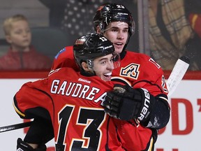 Calgary Flames Johnny Gaudreau and Sean Monahan celebrate after a goal by Jiri Hudler against the Anaheim Ducks during NHL hockey in Calgary, Alta. on Monday February 15, 2016. Al Charest/Postmedia