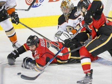 Brandon Bollig of the Calgary Flames watches a puck near teammate Josh Jooris in front of Anaheim Ducks goalie Frederik Andersen in Calgary, Alta., on Monday, Feb. 15, 2016. Lyle Aspinall/Postmedia Network