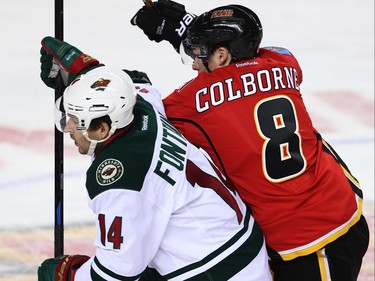 Minnesota Wild Justin Fontaine battles against Joe Colborne of the Calgary Flames during NHL hockey in Calgary, Alta., on Wednesday, February 17, 2016. Al Charest/Postmedia