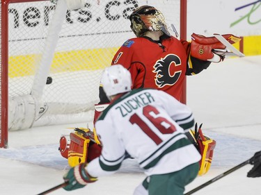 Jason Zucker of the Minnesota Wild scores a short-handed goal on Calgary Flames goalie Jonas Hiller in Calgary, Alta., on Wednesday, Feb. 17, 2016. Lyle Aspinall/Postmedia Network