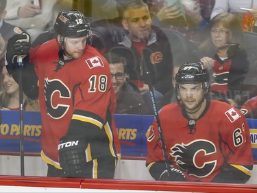 Matt Stajan eyes teammate Michael Frolik of the Calgary Flames in the penalty box during action against the Minnesota Wild in Calgary, Alta., on Wednesday, Feb. 17, 2016. Lyle Aspinall/Postmedia Network